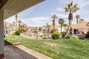 View of grassy yard featuring a residential view and a patio area