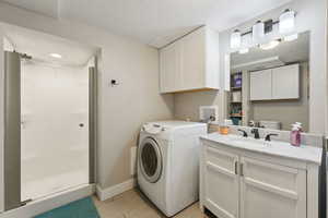 Bathroom with a laundry area and storage