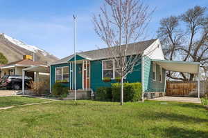 Bungalow-style home featuring a mountain view, a carport, covered patio