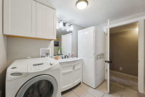 Bathroom with a laundry area and storage