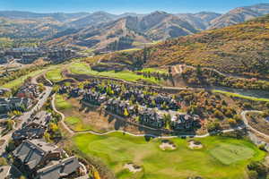 Aerial view with golf course view, a residential view, and a mountain view