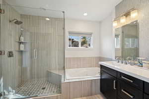 Full bathroom with a stall shower, vanity, and a whirlpool tub