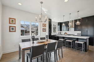 Dining space with a chandelier, recessed lighting, light wood-type flooring, and baseboards