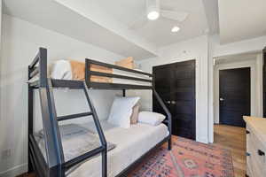Bedroom featuring recessed lighting, a skylight, baseboards, and wood finished floors