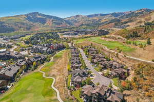 Drone / aerial view with a mountain view, a residential view, and view of golf course