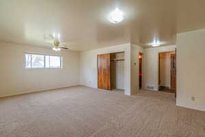Unfurnished bedroom with a closet, carpet flooring, and visible vents