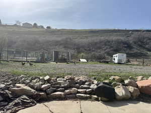 View of yard featuring a rural view and fence