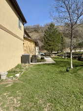 View of yard featuring central AC and a patio
