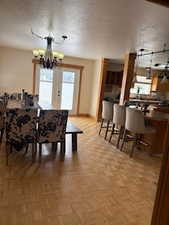 Dining space featuring a chandelier and baseboards