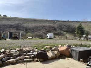 View of yard featuring a rural view and fence