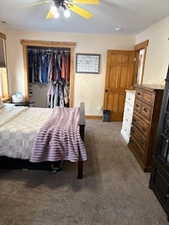 Carpeted bedroom with ceiling fan