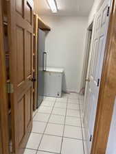 Clothes washing area with light tile patterned flooring