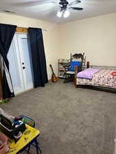 Carpeted bedroom featuring visible vents and ceiling fan