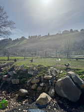 View of yard with fence and a rural view
