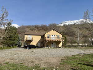Back of property with a deck with mountain view and stucco siding