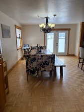 Dining room featuring a chandelier and baseboards