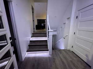 Staircase featuring wood finished floors