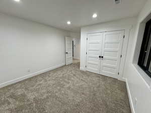 Unfurnished bedroom featuring recessed lighting, carpet, and baseboards