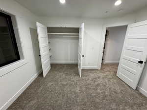 Unfurnished bedroom featuring a closet, baseboards, recessed lighting, and carpet