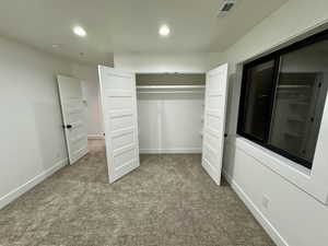 Unfurnished bedroom featuring recessed lighting, carpet flooring, visible vents, and baseboards