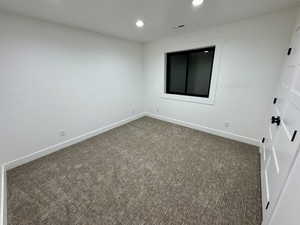 Spare room with visible vents, baseboards, recessed lighting, and carpet floors