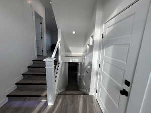 Staircase featuring wood finished floors and baseboards
