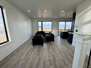 Living area featuring recessed lighting, baseboards, and wood finished floors