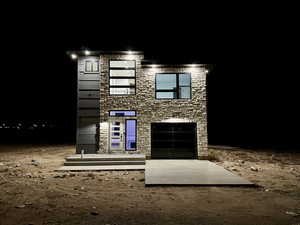 Modern home featuring stone siding