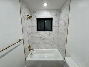 Bathroom with toilet and tub / shower combination