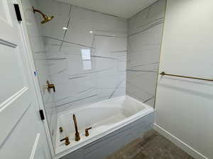Full bathroom with  shower combination, baseboards, and wood finished floors
