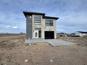 Rear view of house featuring stone siding