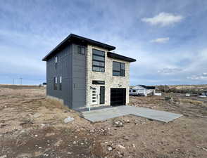 View of outdoor structure with driveway