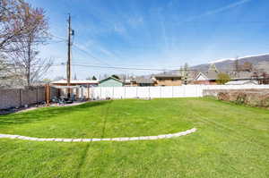 View of yard with a mountain view, a patio, and a fenced backyard