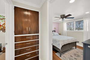 Bedroom featuring crown molding, wood finished floors, baseboards, and recessed lighting