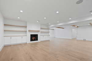 Unfurnished living room with recessed lighting, baseboards, light wood finished floors, and visible vents