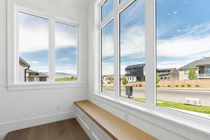 Unfurnished room with dark wood-style flooring and baseboards