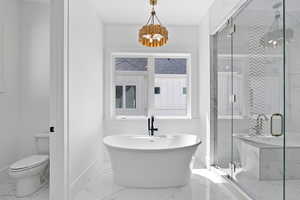 Bathroom featuring a shower stall, a notable chandelier, baseboards, toilet, and marble finish floor