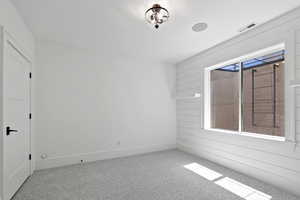 Unfurnished room featuring visible vents, baseboards, and carpet floors