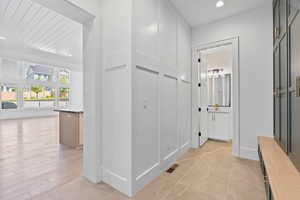 Hallway with recessed lighting and visible vents