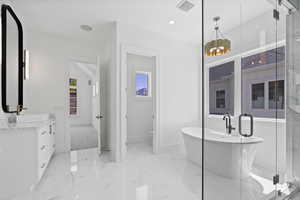 Full bath with a stall shower, visible vents, marble finish floor, and vanity
