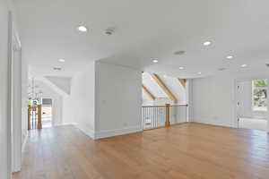 Unfurnished living room featuring baseboards, light wood-type flooring, recessed lighting, and visible vents