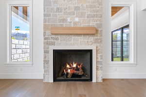 Interior details featuring baseboards, wood finished floors, and a fireplace