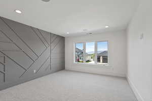 Empty room with recessed lighting, baseboards, and light colored carpet