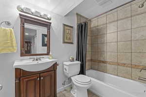 Bathroom featuring vanity, shower / bath combo, tile patterned floors, toilet, and visible vents