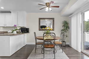 Dining space with recessed lighting, dark wood-type flooring, baseboards, and ceiling fan