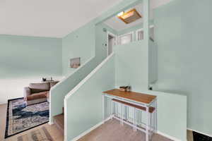 Stairs featuring wood finished floors