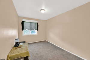 Interior space with carpet floors and baseboards