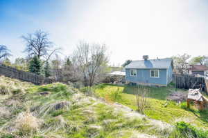 View of yard featuring fence