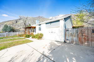 Exterior space featuring a patio, fence, a chimney, and a mountain view