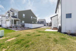 View of yard with entry steps, fence, and a residential view